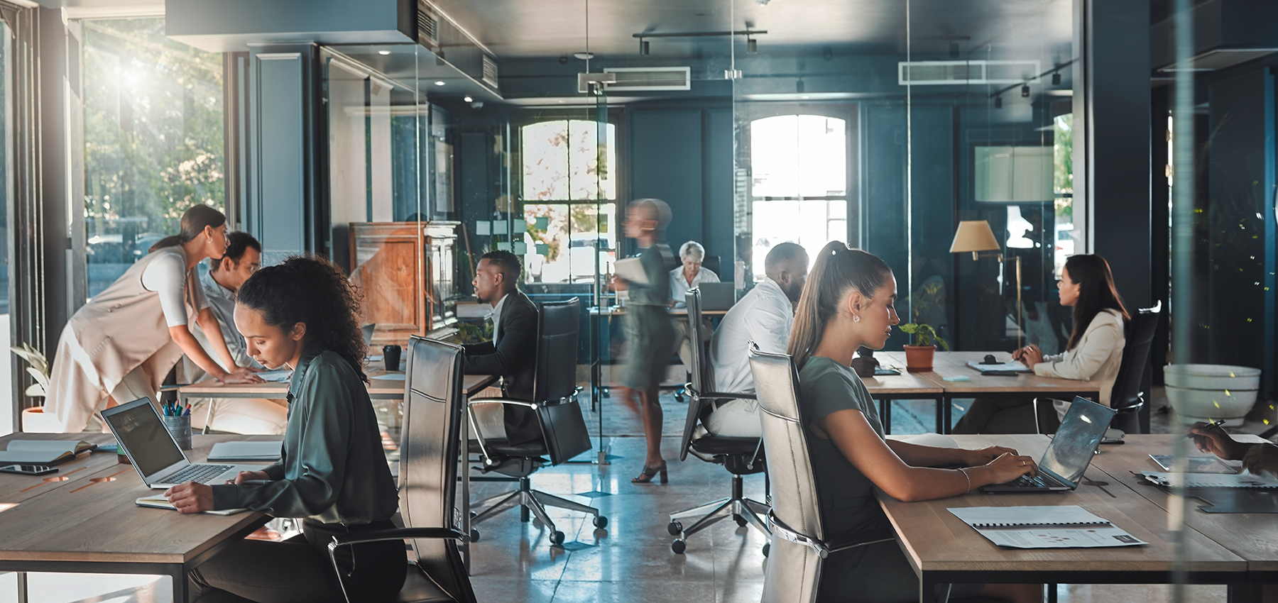 Corporate business people working in busy marketing office space, planning strategy in books and reading email on laptop at work. Businessman, businesswoman and workers at startup advertising company