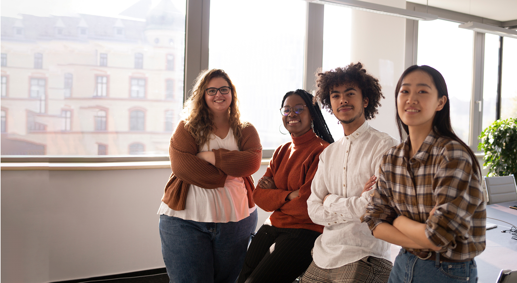 A group of young colleagues in the office looking at the camera