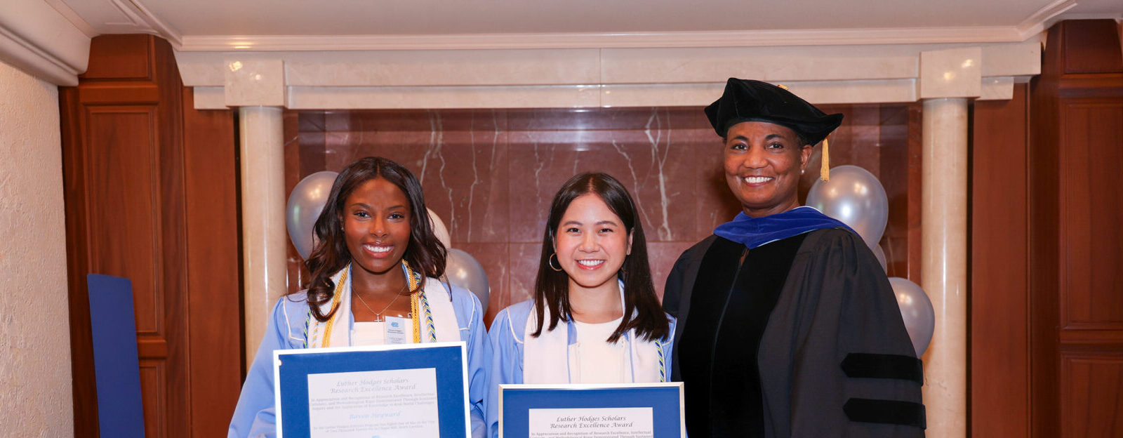 Luther Hodges Scholars Raven Heyward and Chi Vu and program Executive Director Kim Allen at the Class of 2026 Luther Hodges Scholars Graduation Ceremony.