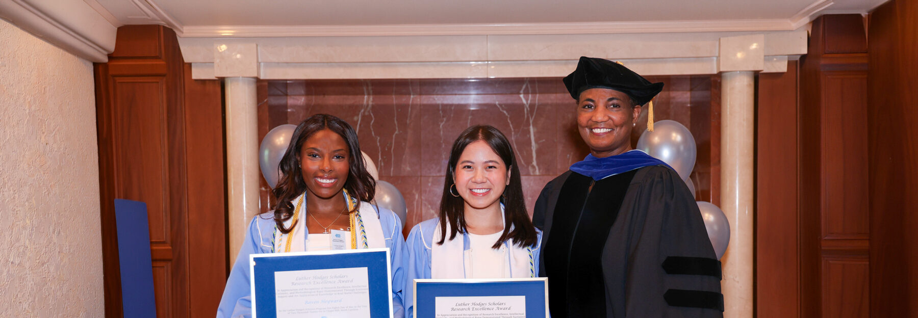 Luther Hodges Scholars Raven Heyward and Chi Vu and program Executive Director Kim Allen at the Class of 2026 Luther Hodges Scholars Graduation Ceremony.