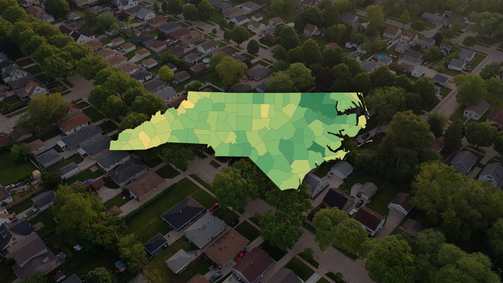 NC housing affordability graphic overlaying an aerial photo of a neighborhood